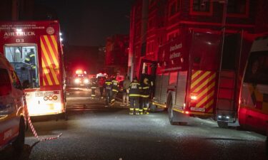 Rescue workers covered bodies in blankets and sheets outside the building.