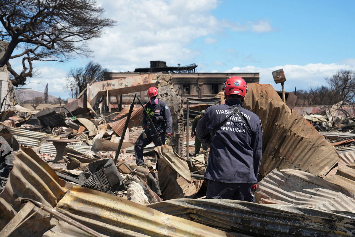 <i>Dominick Del Vecchio/Reuters</i><br/>Members of FEMA urban search and rescue teams go through destroyed neighborhoods in Lahaina