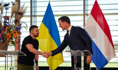 Volodymyr Zelenskiy shakes hands with Mark Rutte.