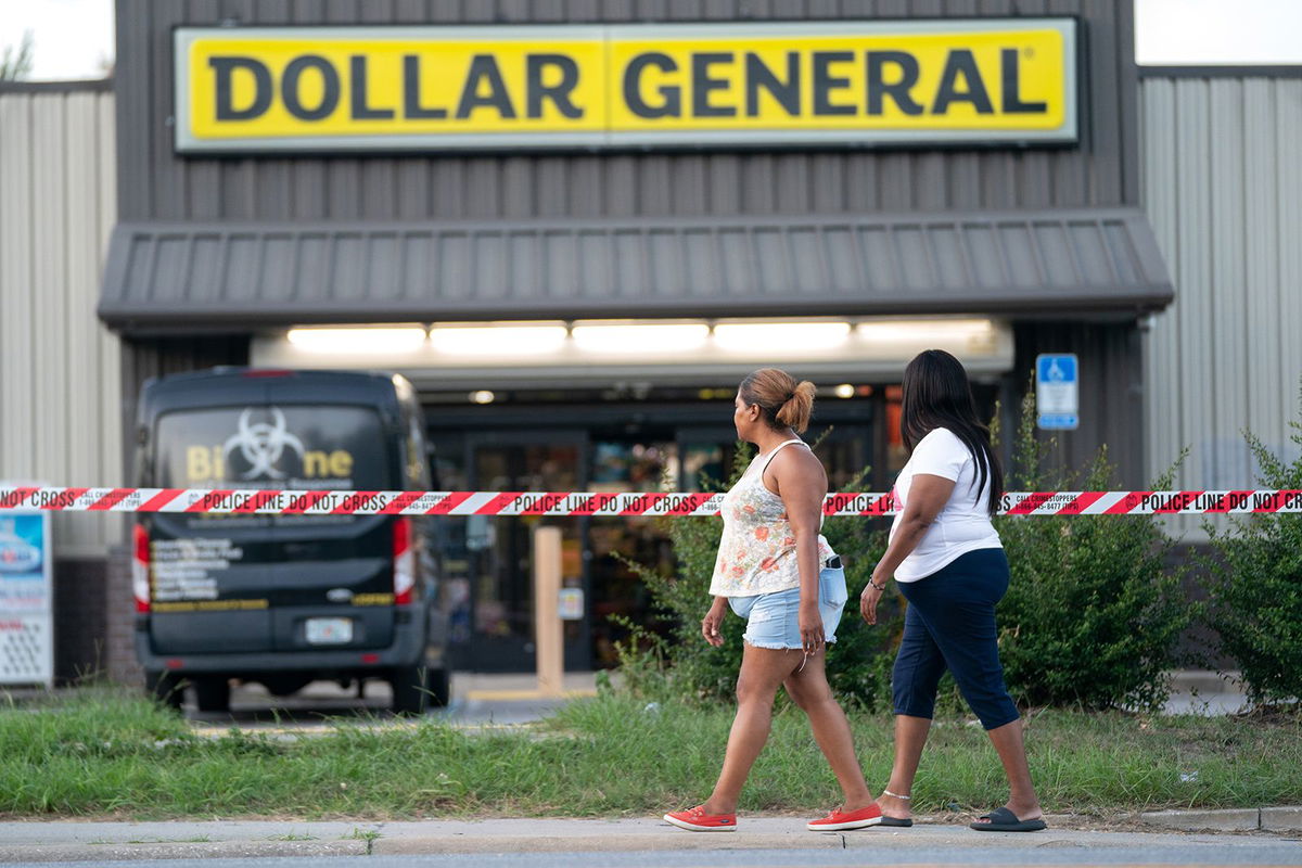 <i>Sean Rayford/Getty Images</i><br/>People walk past the Dollar General store Sunday in Jacksonville