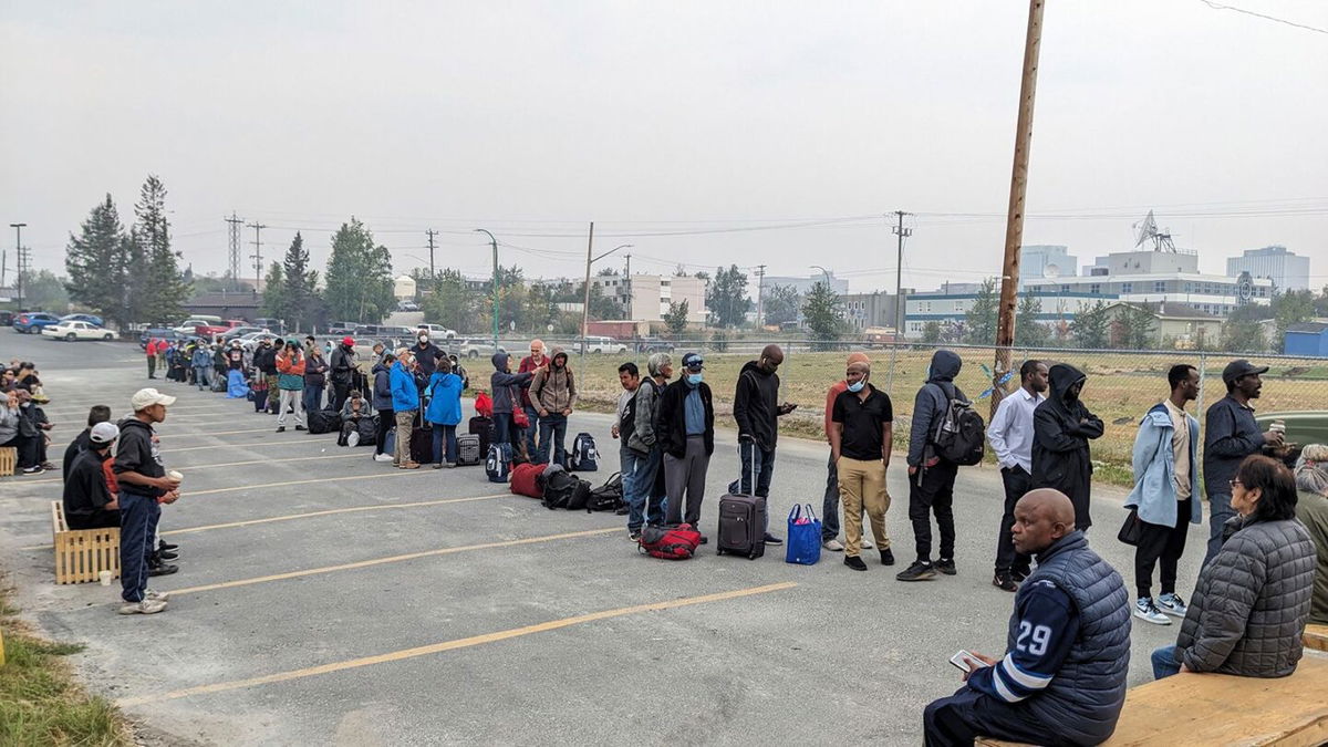 <i>Bill Braden/The Canadian Press/AP</i><br/>People line up in Yellowknife to register for an evacuation flight on August 17.