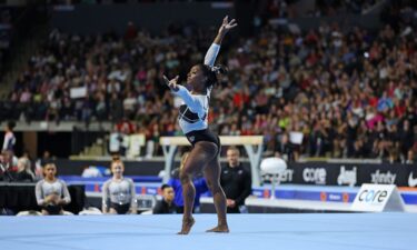 Simone Biles celebrates after winning the all-around competition at the Core Hydration Classic.