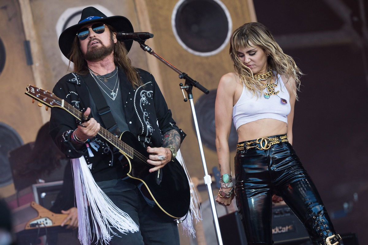 <i>Ian Gavan/Getty Images</i><br/>Billy Ray Cyrus and Miley Cyrus perform together in 2019.