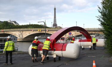 Workers are seen dismantling a temporary venue to host a pre-Olympic swimming test competition that was canceled on August 6.