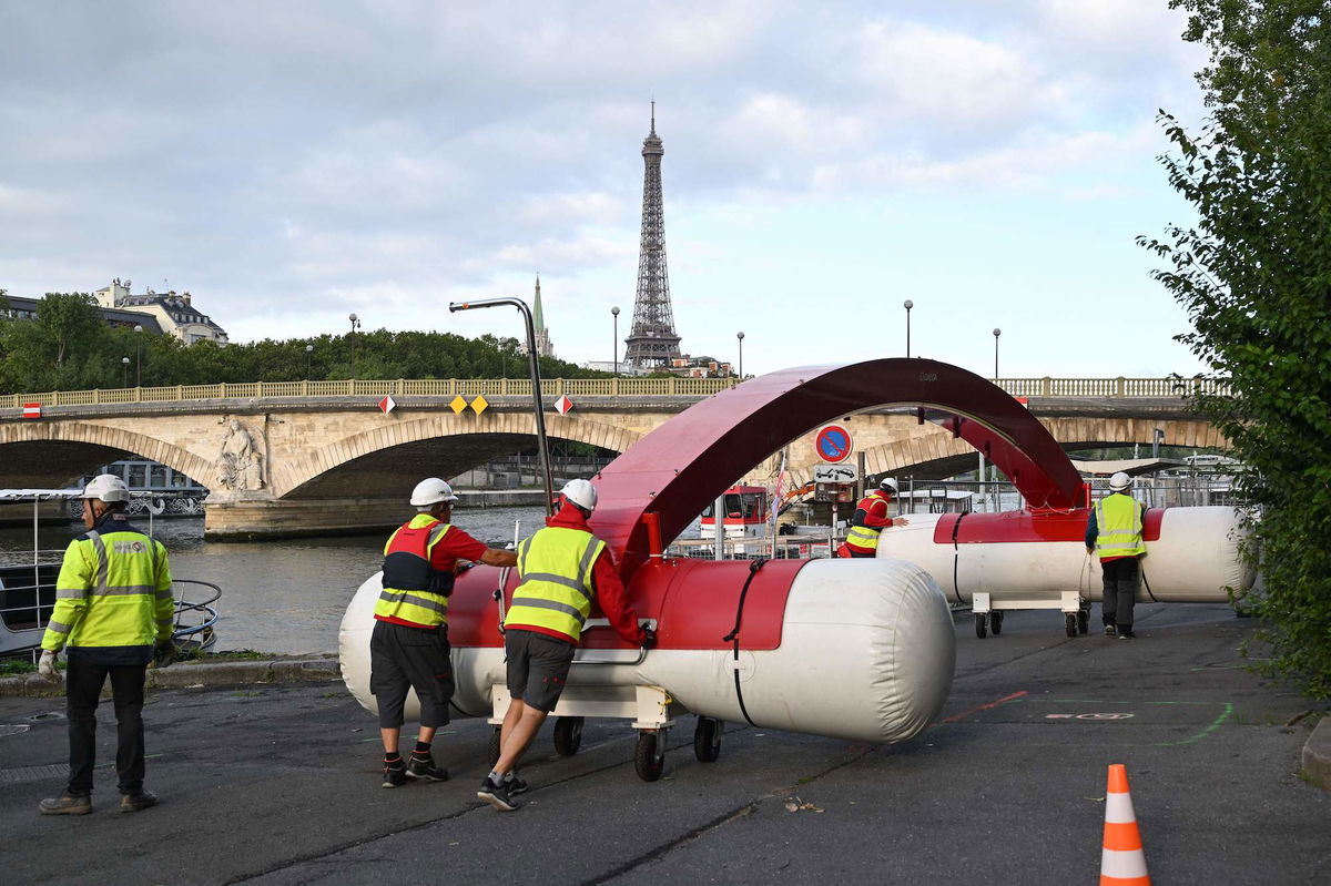 <i>Bertrand Guay/AFP/Getty Images</i><br/>Workers are seen dismantling a temporary venue to host a pre-Olympic swimming test competition that was canceled on August 6.