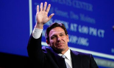 Florida Gov. Ron DeSantis waves at the Republican Party of Iowa's 2023 Lincoln Dinner in Des Moines on July 28.