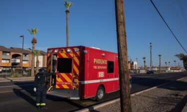 Phoenix-area paramedic waits to transport a resident to the hospital during extreme heat on July 20.