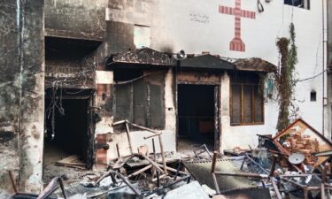 Police inspect a house that was set on fire in a Christian neighborhood in Jaranwala on Wednesday.