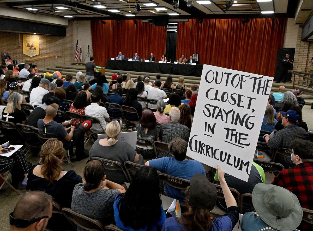 <i>Will Lester/MediaNews Group/Inland Valley Daily Bulletin/Getty Images/FILE</i><br/>A gay and transgender students' rights supporter holds a sign during a board meeting of the Chino Valley Unified School District at Don Lugo High School in Chino