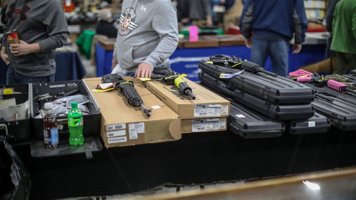<i>Kimberly P. Mitchell/Detroit Free Press/USA Today Network</i><br/>People browse guns for sale during the Novi Gun and Knife Show at Suburban Collection Showplace in Novi