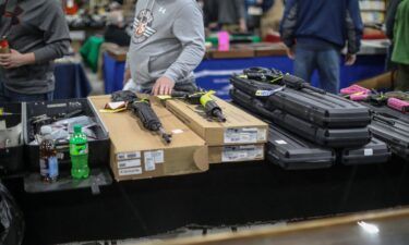 People browse guns for sale during the Novi Gun and Knife Show at Suburban Collection Showplace in Novi
