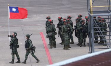 A Taiwanese soldier holds a Taiwan national flag at Taoyuan International Airport in Taoyuan