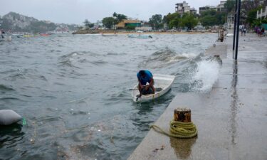 A man moors his boat in Acapulco