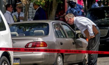 Authorities work the scene after a Philadelphia police officer fatally shot a man Monday.