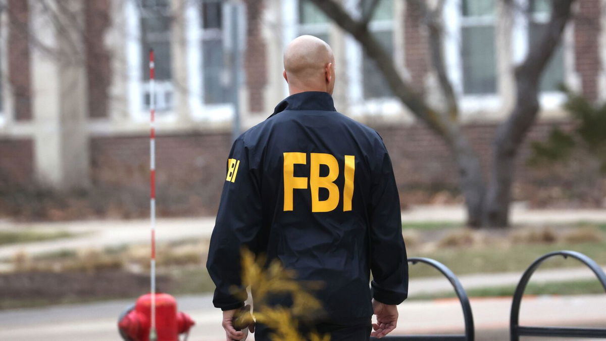 <i>Scott Olson/Getty Images</i><br/>An FBI agent wearing a windbreaker is seen in February 2023.