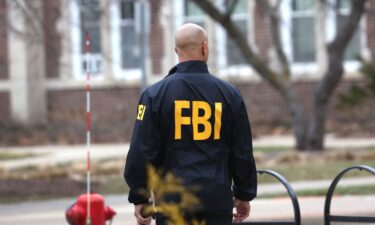 An FBI agent wearing a windbreaker is seen in February 2023.