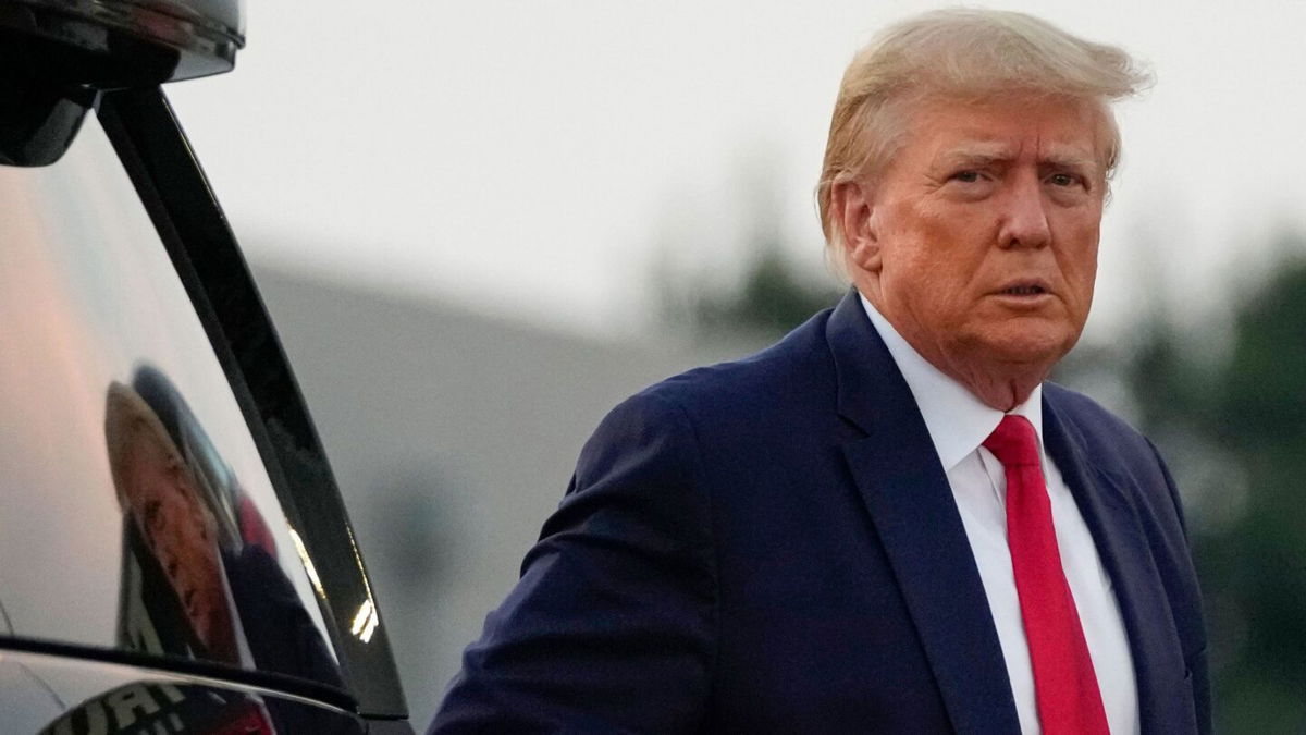 <i>Alex Brandon/AP</i><br/>Former President Donald Trump walks to speak with reporters before departure from Hartsfield-Jackson Atlanta International Airport