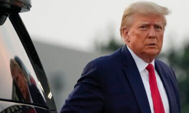 Former President Donald Trump walks to speak with reporters before departure from Hartsfield-Jackson Atlanta International Airport