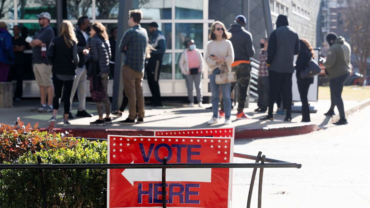 <i>Megan Varner/Reuters/FILE</i><br/>Voters line up at the Metropolitan Library to cast their ballots in the runoff election for the Senate position