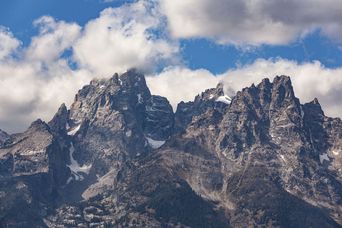 <i>Jon G. Fuller/VWPics/AP</i><br/>Clouds cover peaks in Grand Teton National Park. A woman died after falling off of Teewinot Mountain