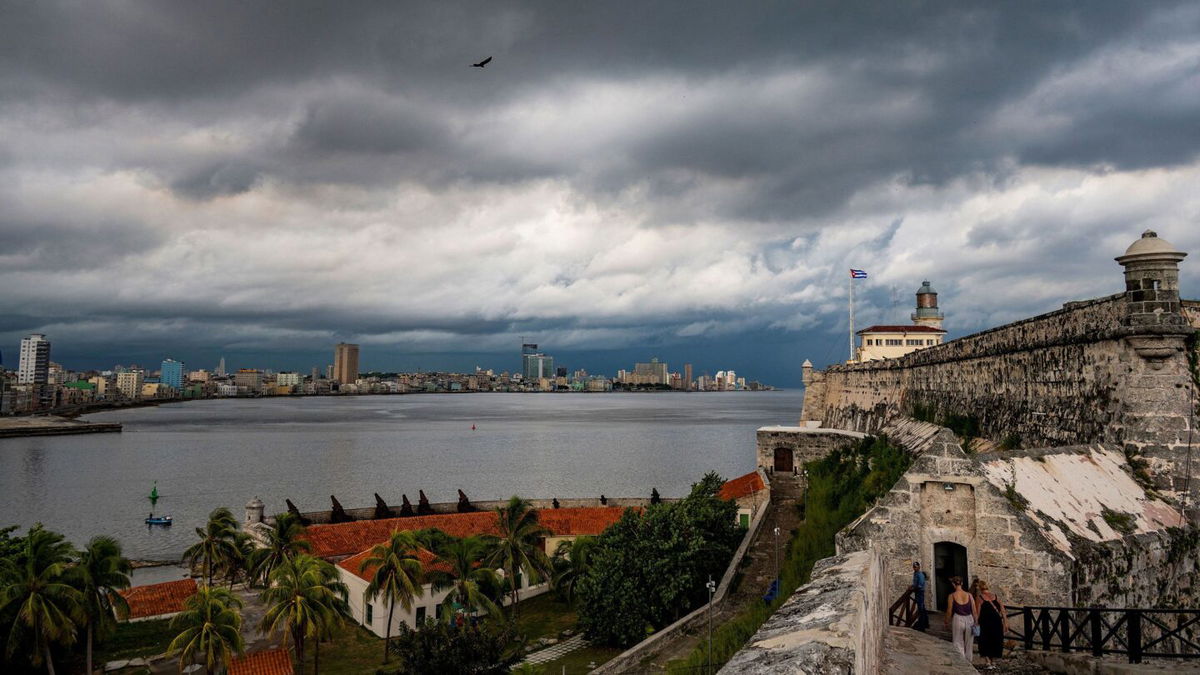 <i>Yamil Lage/AFP via Getty Images</i><br/>Dark clouds from tropical storm Idalia blanket the skies in Havana