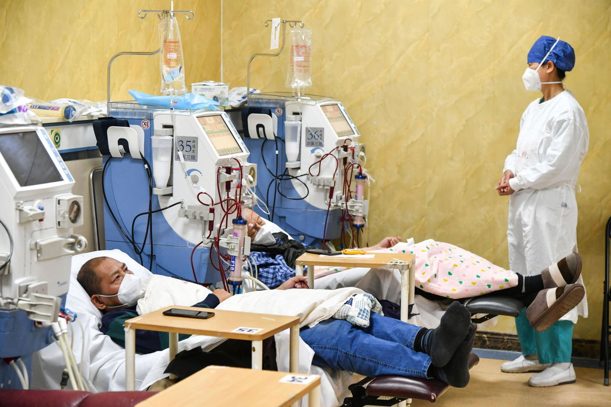 <i>Jade Gao/AFP/Getty Images</i><br/>People wait in the emergency department of a hospital in Beijing amid a surge of Covid-19 cases at the start of the year.