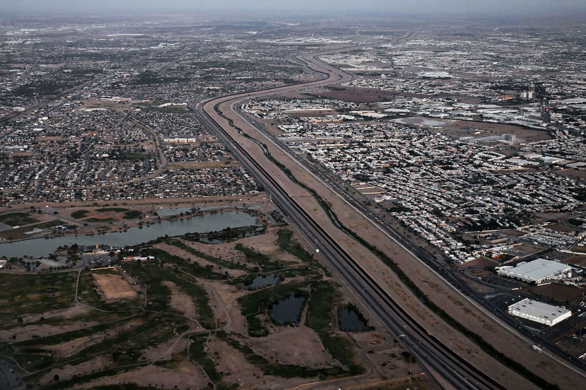 <i>Patrick T. Fallon/AFP/Getty Images</i><br/>This aerial image from May 12 shows a border wall and concertina wire barriers standing along the Rio Grande between El Paso