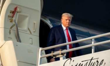 Donald Trump exits his private plane after arriving in Atlanta on Thursday