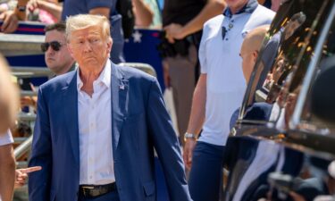 Republican presidential candidate and former President Donald Trump is directed to his vehicle after speaking at the Steer N' Stein bar at the Iowa State Fair on August 12 in Des Moines