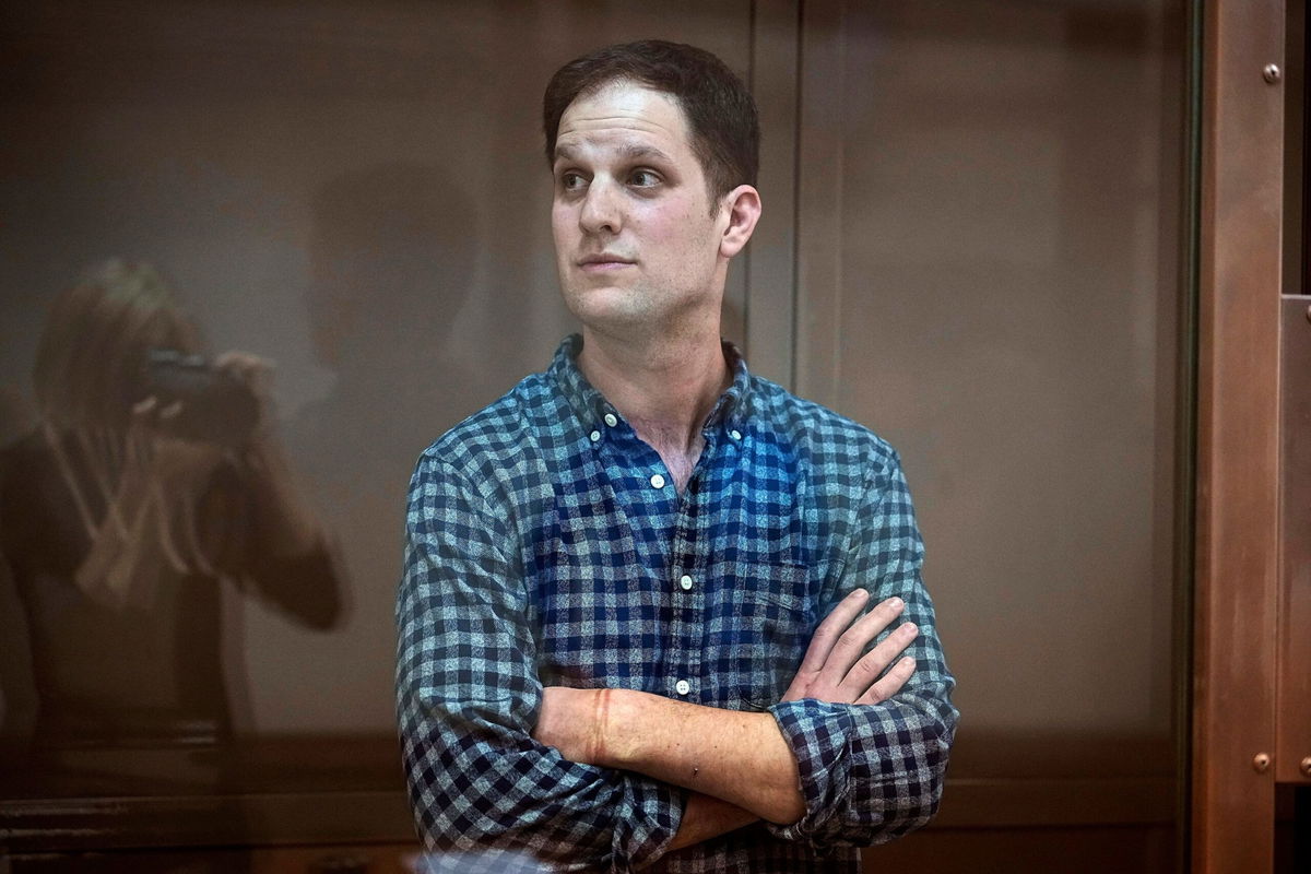 <i>Alexander Zemlianichenko/AP/FILE</i><br/>Evan Gershkovich stands in a glass cage in a courtroom at Moscow City Court on April 18