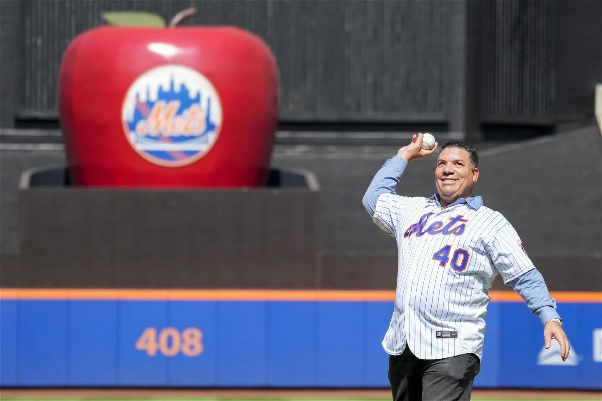 Former New York Mets pitcher Bartolo Colon delivers the first pitch before the start between New York Mets and Cincinnati Reds