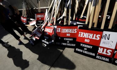 WGA members turn in their signs at the end of their first day of their strike in front of Paramount Studios in Hollywood on May 2.