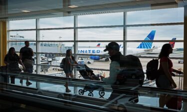 Passengers walk between terminals at Ronald Reagan Washington National Airport on August 8 in Arlington