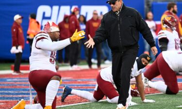 Commanders defensive tackle Daron Payne (94) shakes hands with Washington Commanders head coach Ron Rivera.