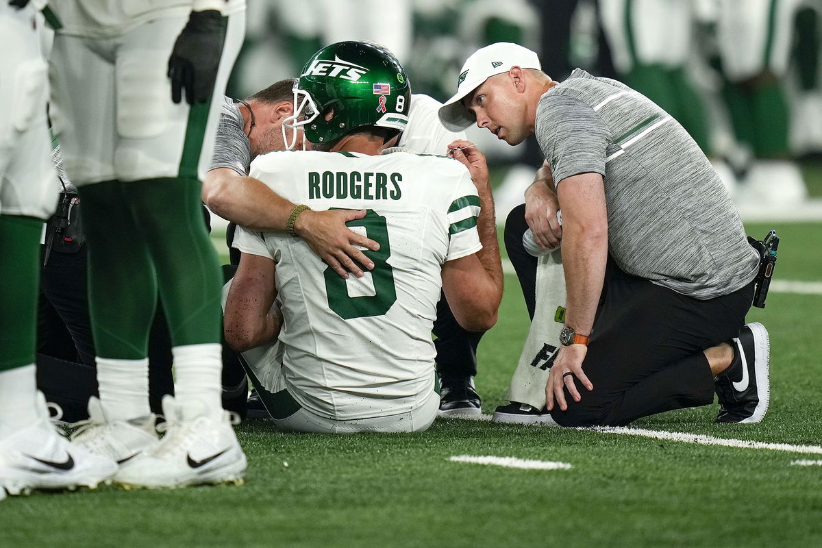 <i>Seth Wenig/AP</i><br/>Rodgers being tended to on the field before he was taken off and missed the remainder of the game.