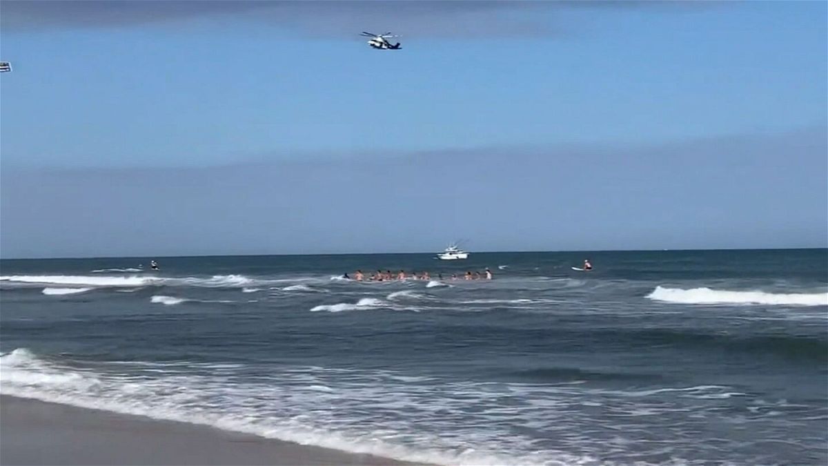<i>WABC</i><br/>Lifeguards created a human chain during a rescue attempt to search for one victim that was submerged in Beach Haven