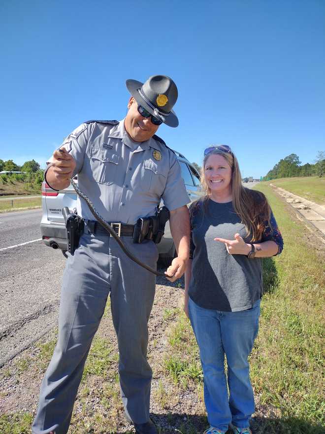 <i>South Carolina Department of Public Safety/WYFF</i><br/>The trooper released the snake in a swamp near his office.