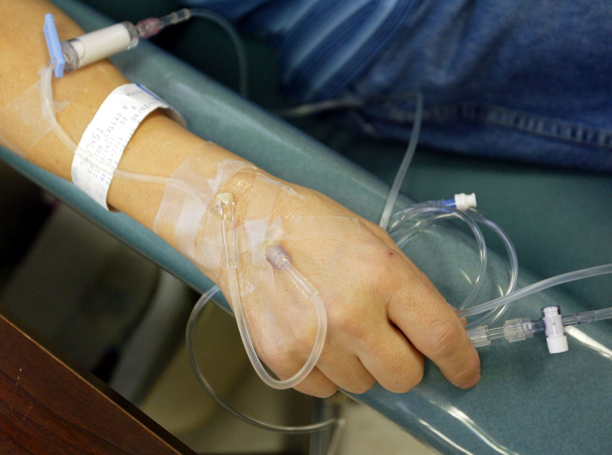 <i>Chris Hondros/Getty Images/File</i><br/>A cancer patient holds the IV tubes during chemotherapy. Some of the nation’s largest cancer centers are reporting little improvement in an ongoing shortage of critical chemotherapy drugs in the United States.