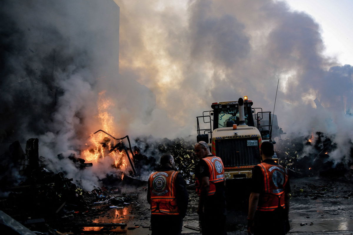 <i>Omar El-Qattaa/AFP/Getty Images</i><br/>Smoke rises from buildings as rescuers work following an Israeli strike on Gaza