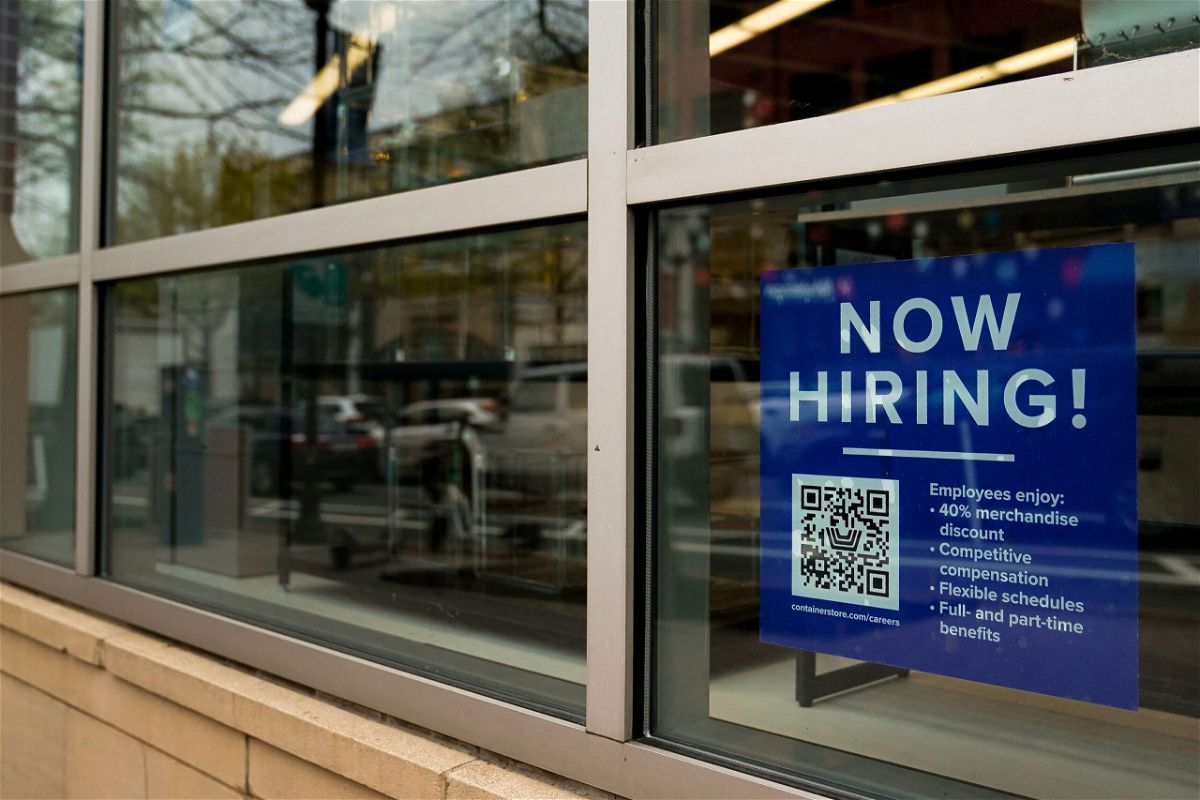 <i>Elizabeth Frantz/Reuters</i><br/>An employee hiring sign with a QR code is seen in a window of a business in Arlington
