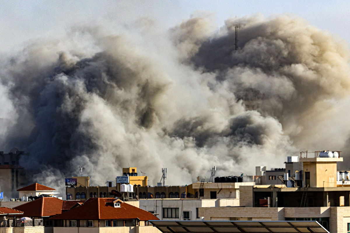 Smoke plumes rise over Gaza City on October 7 during Israeli air strikes. Palestinian militants have begun a "war" against Israel