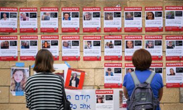 Photographs of some of the people taken hostage by Hamas are seen in posters on October 18