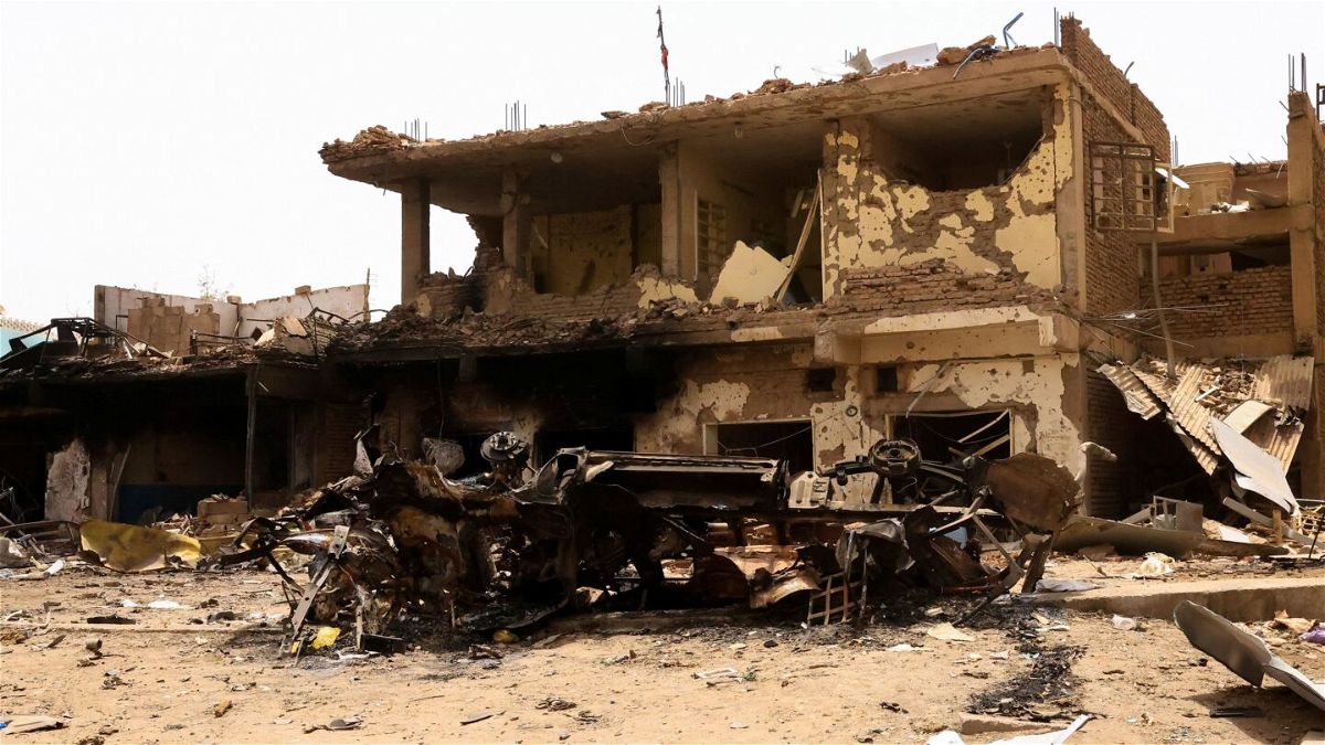 <i>Mohamed Nureldin Abdallah/Reuters</i><br/>A damaged car and buildings are seen at the central market during clashes between the paramilitary Rapid Support Forces and the army in Khartoum North
