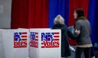 Residents arrive to vote in the New Hampshire primary at a polling location in Manchester on February 11