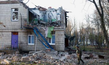 Police officers inspect the compound of a kindergarten damaged during Russian drone strikes in Kyiv