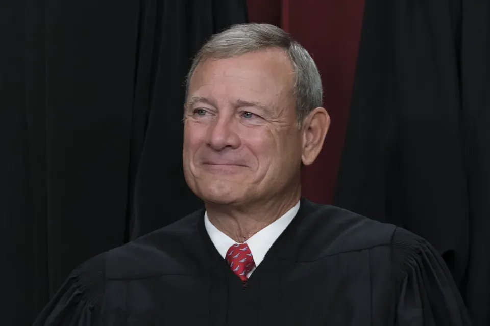 Chief Justice of the United States John Roberts joins other members of the Supreme Court as they pose for a new group portrait, at the Supreme Court building in Washington, Friday, Oct. 7, 2022
