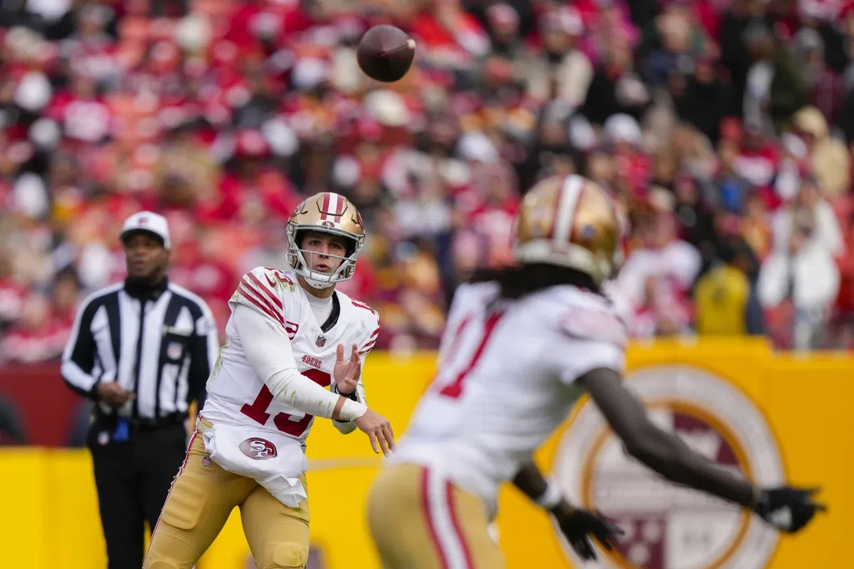 San Francisco 49ers quarterback Brock Purdy throwing a pass to wide receiver Brandon Aiyuk during the second half of an NFL football game