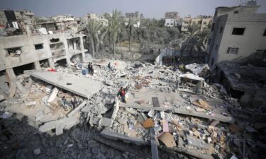 An aerial view of a destroyed residential area as Palestinians try to collect usable items under the rubbles of a building