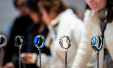 Apple smartwatches are displayed as customers wait to buy them at the Apple store in New York