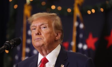 Former President Donald Trump looks on during a campaign event in December 2023 in Waterloo